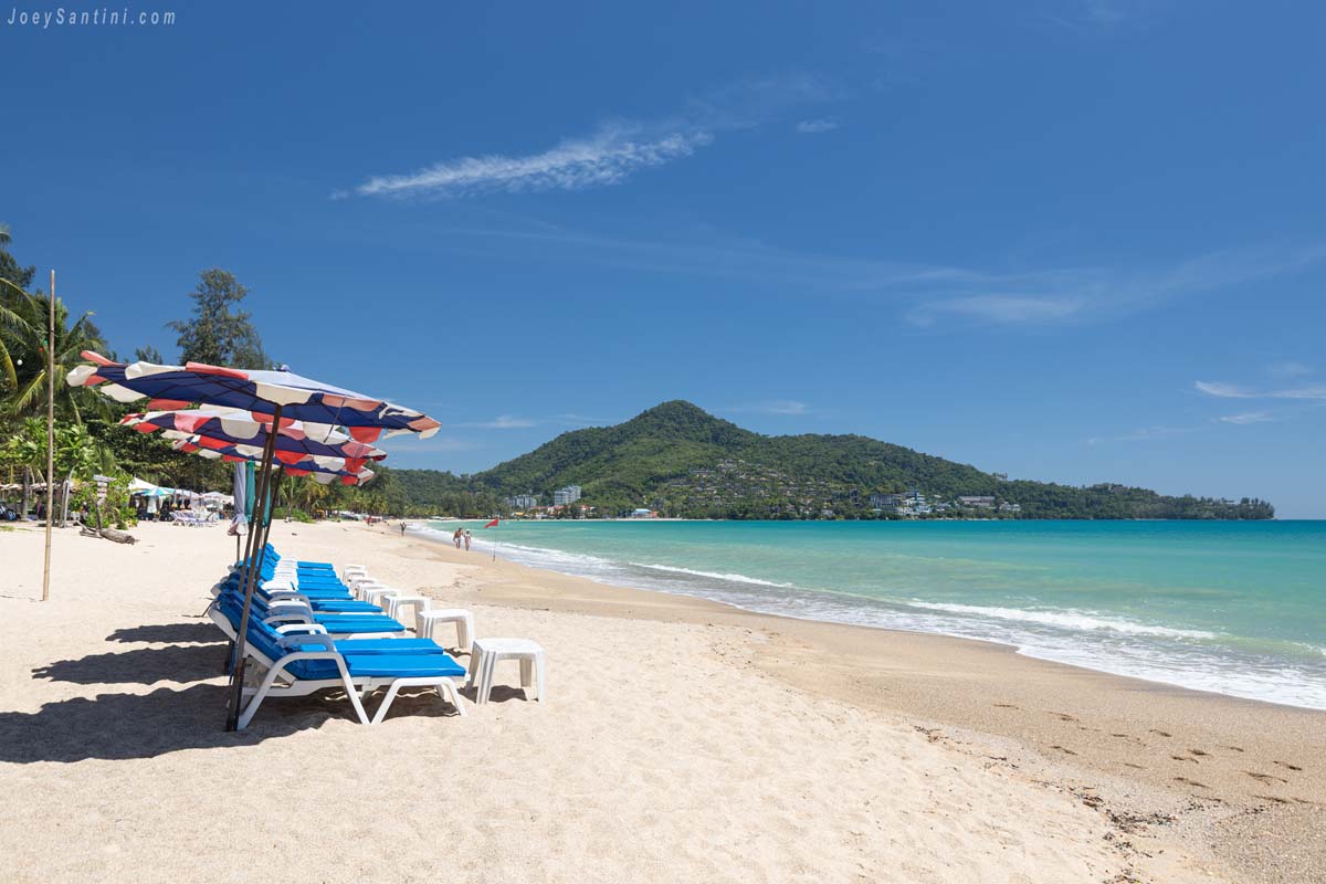 Shot of gold sand and turquoise sea water with blue sky in the background